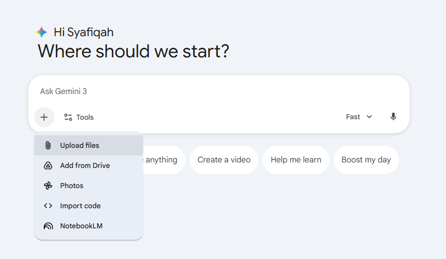 Tangkapan skrin yang menunjukkan menu timbul (pop-up) selepas menekan ikon tambah (+). Menu tersebut memaparkan pilihan "Upload files", "Add from Drive", "Photos", "Import code", dan "NotebookLM".