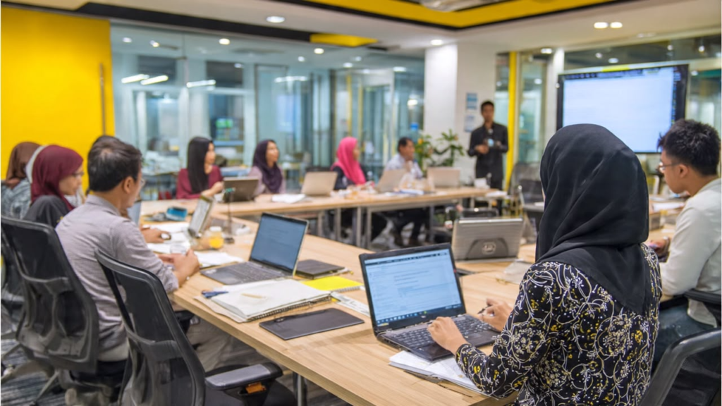 Employees participating in an HRD Corp claimable training course in a corporate workshop setting.